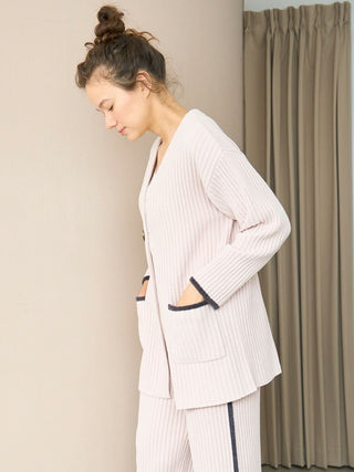 Woman wearing Air Moco x Smooth Ribbed Knit Cardigan with deep V-neck and oversized single-button closure