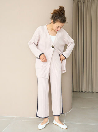Woman wearing Air Moco x Smooth Ribbed Knit Cardigan with deep V-neck and oversized button closure, styled for modern comfort.