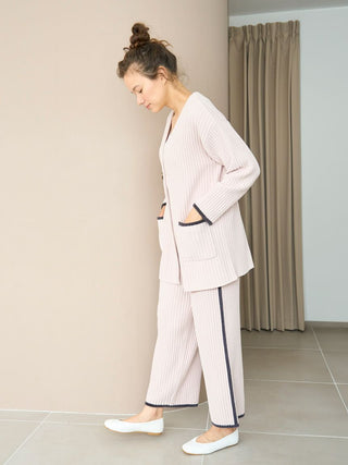 Woman wearing Air Moco x Smooth Ribbed Knit Cardigan with matching pants, showcasing minimalist style with deep V-neck and oversized fit.
