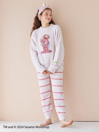 Child wearing Sesame Street motif jacquard pullover and long pants set made from soft Baby Moco fabric.