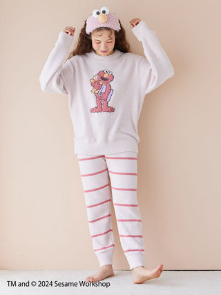 Child wearing Sesame Street motif jacquard pullover and long pants set with Elmo design, made from soft Baby Moco fabric.