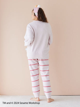 Person wearing SESAME STREET motif jacquard pullover and striped long pants set made with soft Baby Moco fabric, back view.