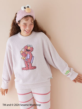 Woman wearing a SESAME STREET motif jacquard pullover and long pants set with Elmo design, made from soft Baby Moco fabric.