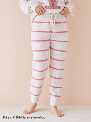 Person wearing SESAME STREET Baby Moco pullover and pants set with pink motif, showcasing soft, lightweight fabric.