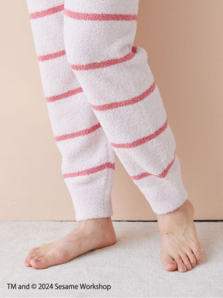 Photo of a person wearing striped Baby Moco pants from the Sesame Street Motif Jacquard Pullover & Long Pants Set, showing soft fabric texture.