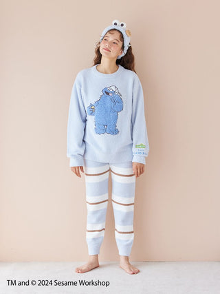 Woman wearing Sesame Street motif pullover & pants set in soft Baby Moco fabric with Cookie Monster design.