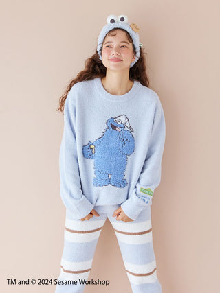 Woman wearing a Sesame Street Jacquard Pullover featuring Cookie Monster and matching long pants, made with soft Baby Moco fabric.