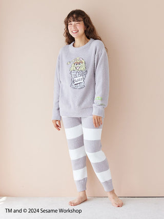 Woman wearing SESAME STREET motif jacquard pullover and long pants set, made with soft 'Baby Moco' fabric, featuring character design.