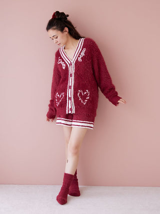 Woman wearing a red feather button up cardigan with festive design, showcasing elegance and warmth for winter