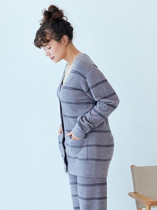 Woman wearing Gelato Pique Hot Smoothie Border Cardigan in striped pattern, showcasing warmth and style for cozy days.