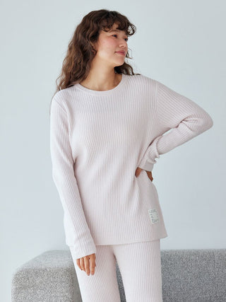 Model wearing Hot Smoothie Rib Pullover Sweater, showcasing cozy ribbed design in soft pink fabric.