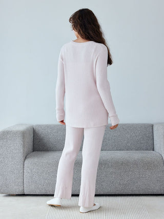 Back view of a model wearing the Hot Smoothie Rib Pullover Sweater, showcasing its soft ribbed texture and modern design.