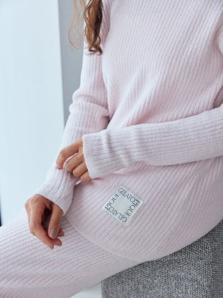 Woman wearing a light pink hot smoothie rib pullover sweater from Gelato Pique, showcasing a cozy ribbed design perfect for chilly days.