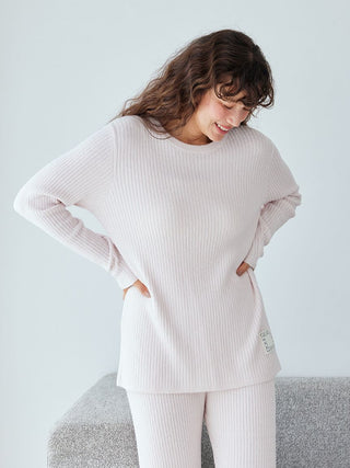 Woman wearing Hot Smoothie Rib Pullover Sweater in soft pink, showcasing its ribbed texture and cozy, lightweight design for warmth.