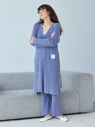 Woman wearing Hot Smoothie Ribbed Long Cardigan in cozy setting. Stylish loungewear by Gelato Pique with ribbed texture and sleek silhouette.