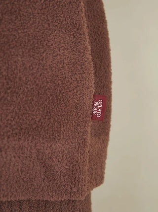 Close-up of Babymoco Chocolate Button-Up Cardigan's soft fabric with Gelato Pique tag, highlighting its cozy, rich texture.