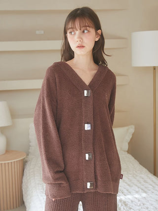 Woman wearing Babymoco Chocolate Button-Up Cardigan, showcasing soft and warm fabric in a cozy room setting.