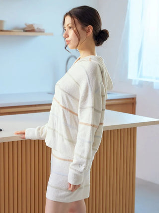 Woman wearing Smoothie Colorful Zip-Up Hoodie in cozy indoor setting, showcasing Gelato Pique's soft and playful design.