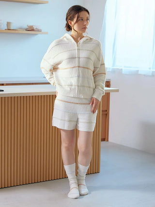 Woman wearing a Smoothie Colorful Zip-Up Hoodie with soft stripes, showcasing cozy and stylish loungewear by Gelato Pique USA.
