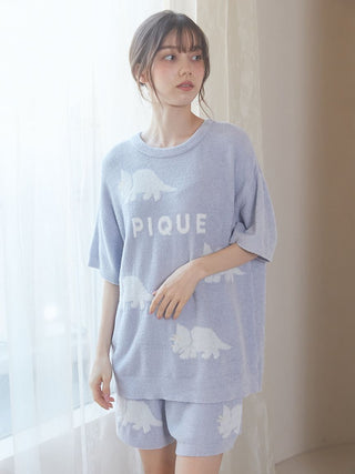 Woman wearing Smoothie Dinosaur Pullover & Shorts Loungewear Set in light blue with playful dinosaur pattern.