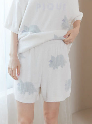 Person wearing Smoothie Dinosaur Pullover & Shorts Loungewear Set in white with dinosaur pattern, showcasing cozy and playful design.