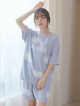 Woman wearing Smoothie Dinosaur Pullover & Shorts Loungewear Set in cozy purple fabric with dinosaur design by Gelato Pique USA.
