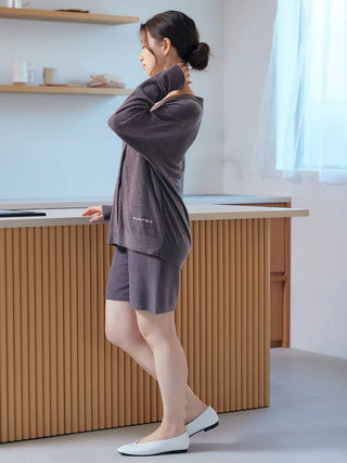 Woman wearing Smoothie Lite Button Up Cardigan by Gelato Pique USA, premium loungewear, in a relaxed home setting.