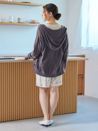 Woman wearing Smoothie Lite Hoodie Jacket by Gelato Pique USA, showcasing premium loungewear and sleepwear in a calm setting.