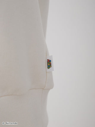 Close-up of Super Mario fleece pullover with logo tag, showing soft, fluffy fabric and ribbed hem design for unisex set.