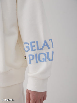 Super Mario unisex fleece pullover close-up of sleeve with blue "GELATO PIQUE" logo, showcasing soft cotton fabric and elastic hem.