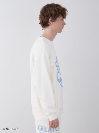 Model wearing SUPER MARIO™️ Unisex Fleece Pullover featuring a puff print of Mario, styled with matching long pants in a side profile view.