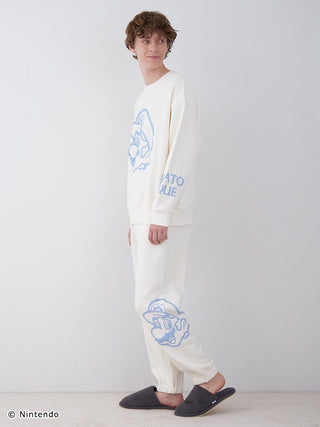 Model wearing SUPER MARIO™️ Unisex Fleece Pullover & Long Pants Set with three-dimensional Mario print, soft cotton fabric.