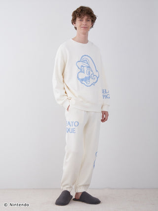 Model wearing Super Mario unisex fleece pullover and pants set with foam print, featuring Mario and Boo designs, cotton-lined fabric.