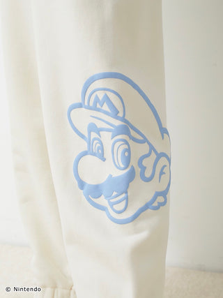 White fleece pants featuring a blue three-dimensional Mario print on the thigh.