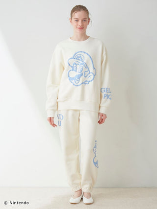 Unisex fleece pullover and pants set featuring Mario design, soft cotton fabric, and elastic hems displayed by a model.