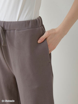 Close-up of dark gray unisex fleece pants from the Super Mario set, showing the elastic waist and soft cotton fabric.