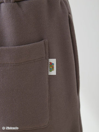 Close-up of Super Mario unisex fleece pants with pocket and logo tag
