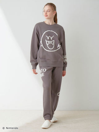 Unisex fleece pullover and pants set with Mario and Boo print, soft cotton fabric, shown on a model, featuring elasticized hems.