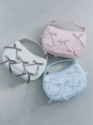 Three Gelato Pique Ribbon Handle Pouches in pink, white, and blue, showcasing luxurious matte fabric and elegant design.