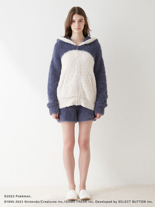 Woman wearing Pokémon Sleep Snorlax themed hoodie and shorts set, cozy blue and cream design.
