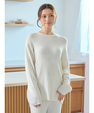 Woman wearing a white Thermal Smoothie Pullover Sweater with ribbed texture, standing in a modern kitchen.