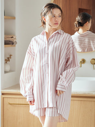 Woman wearing Gelato Pique USA striped long sleeve pajama shirt, showcasing relaxed elegance and silky-smooth comfort.