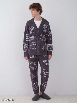 Man wearing a Super Mario themed Baby Moco jacquard cardigan with ally and enemy patterns, styled with matching loungewear pants.