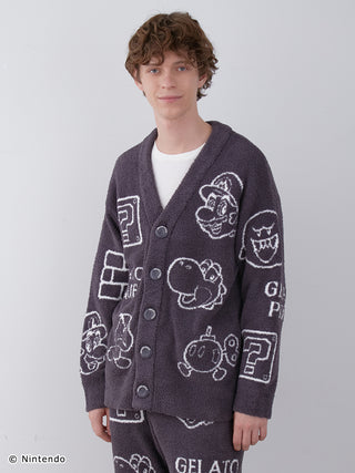 Man wearing a dark gray Baby Moco cardigan with Super Mario character jacquard patterns, featuring various iconic game motifs.