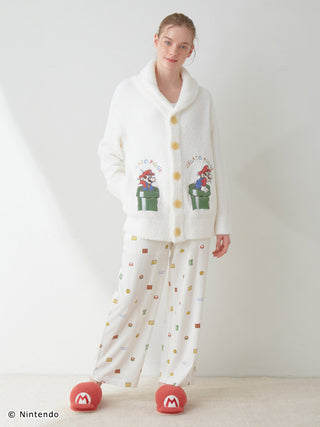 Person wearing SUPER MARIO™️ Unisex Baby Moco Jacquard Shawl Cardigan with Mario design, soft and fluffy knitwear, Nintendo fashion.