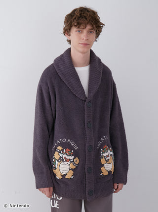 Model wearing Super Mario Unisex Baby Moco Jacquard Shawl Cardigan with Bowser design, soft and fluffy knitwear.