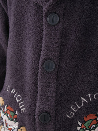 Close-up of Super Mario unisex Baby Moco jacquard shawl cardigan with buttons and character design. Soft, fluffy fabric.
