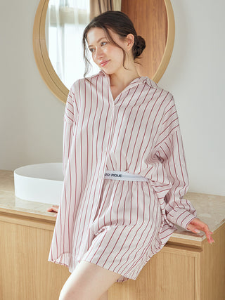 Woman wearing striped long sleeve pajama shirt by Gelato Pique USA, showcasing the elegant and relaxed sleepwear design.