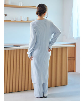 Back view of woman wearing a ribbed Thermal Smoothie Long Cardigan in a modern kitchen setting.