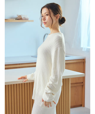 Woman wearing Thermal Smoothie Pullover Sweater, showcasing its ribbed texture and sleek silhouette, in a modern kitchen setting.